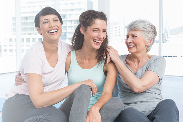 Cheerful fit women sitting in the yoga class